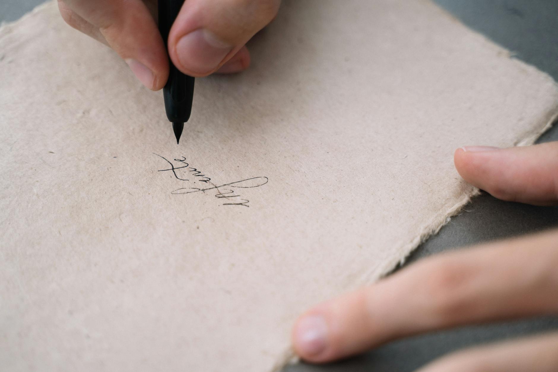 close up shot of a person writing on a paper